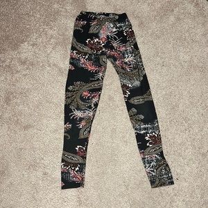 Small leggings. Black with a white and pink design. Gently used.